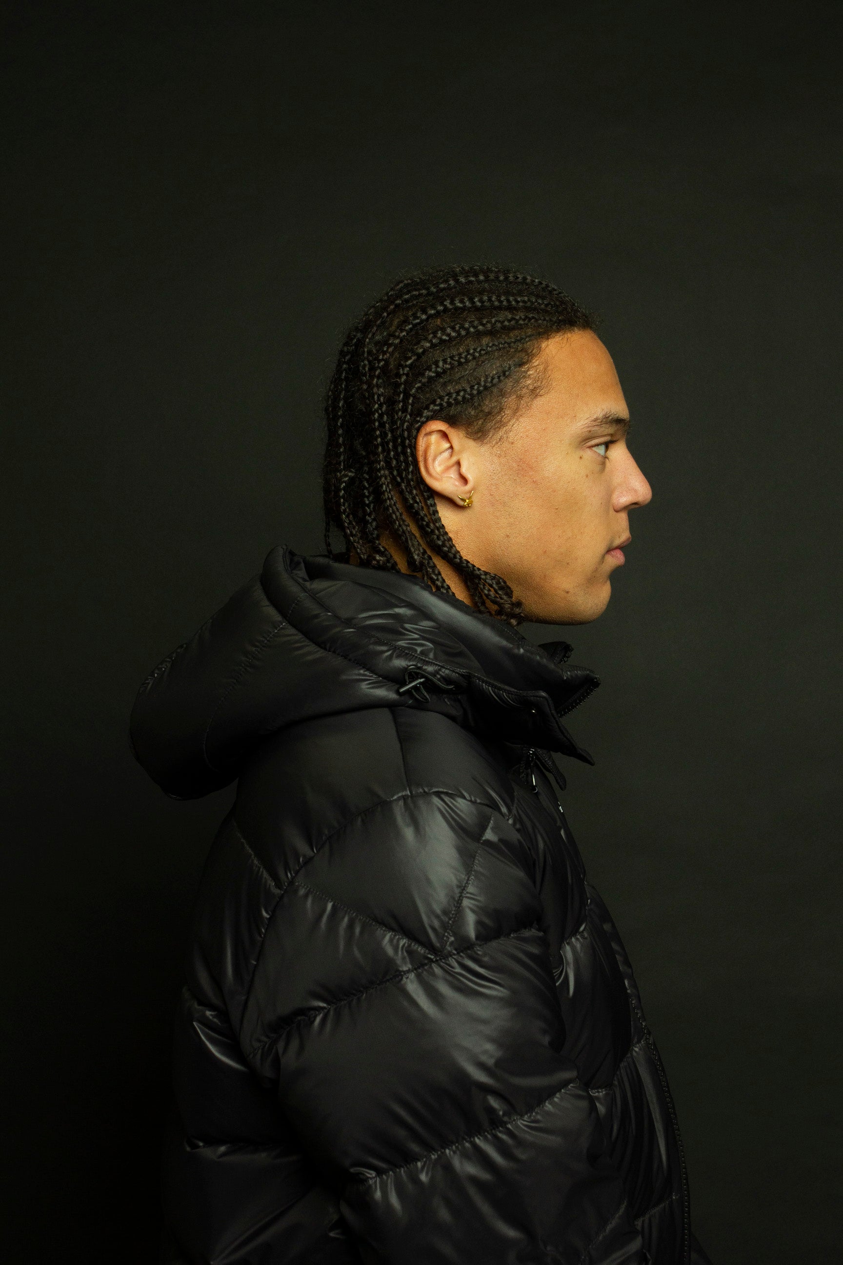 ARCÉVE The Mont Jacket - Close-up of ARCÉVE black hooded down jacket