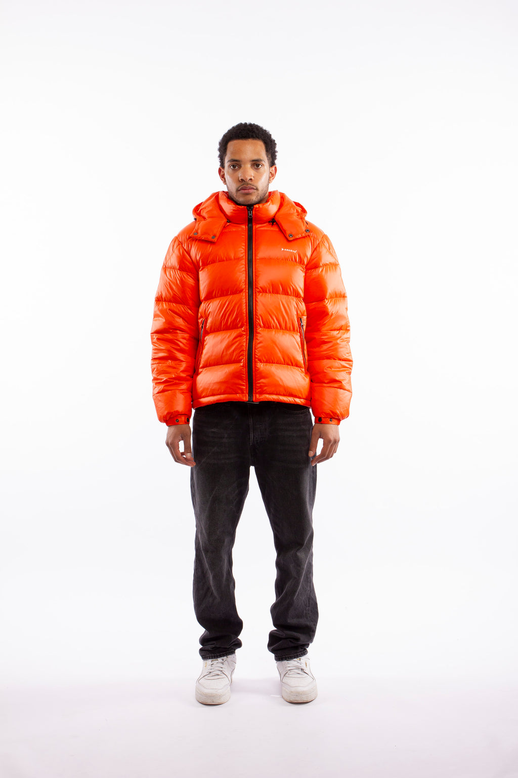 ARCÉVE The Mont Jacket - Model wearing the premium down puffer jacket - Orange