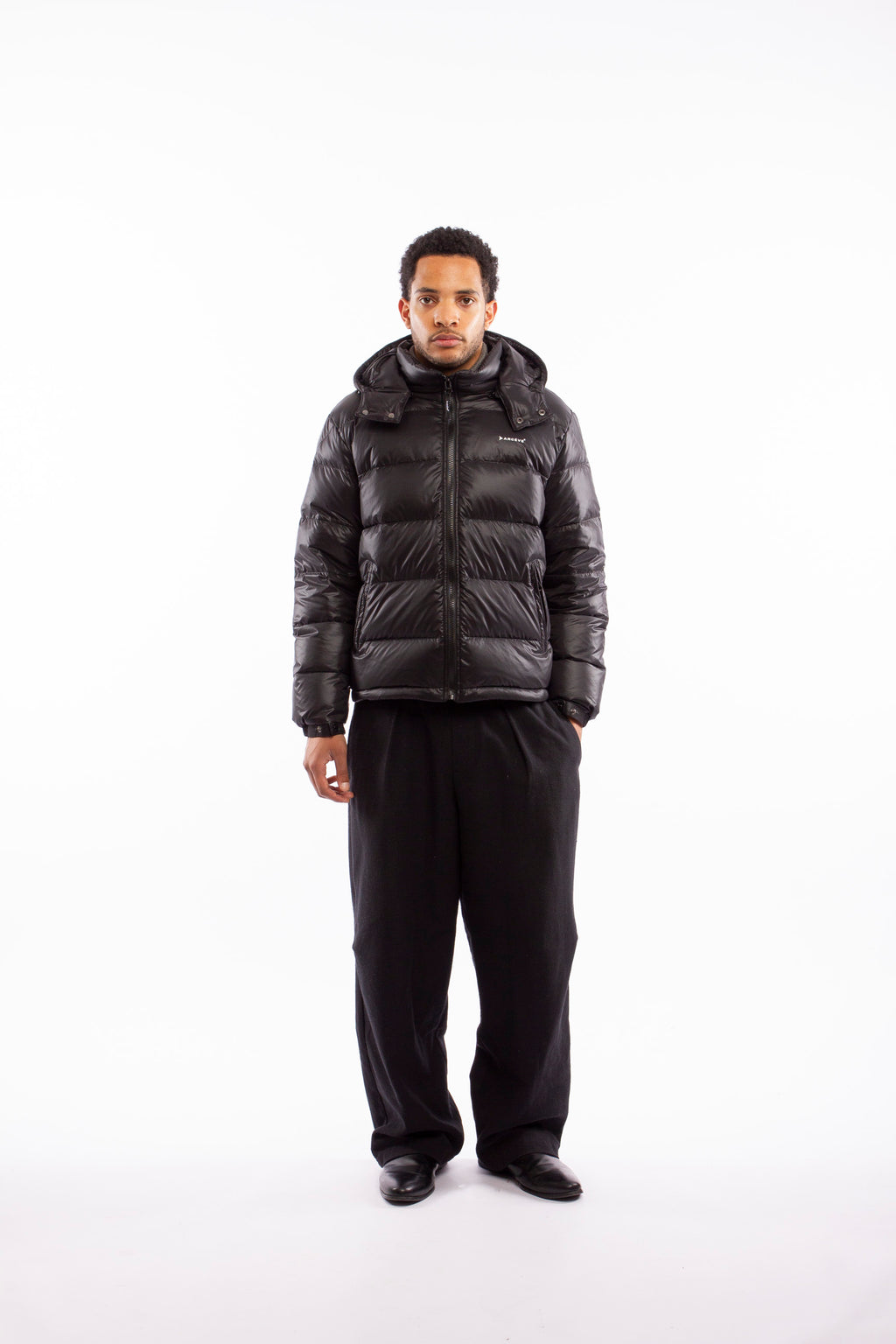 ARCÉVE The Mont Jacket - Model wearing the premium down puffer jacket - Black