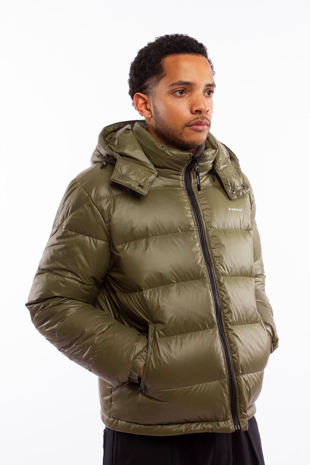 ARCÉVE The Mont Jacket - Close-up of the signature ARCÉVE logo on the chest  -  Khaki