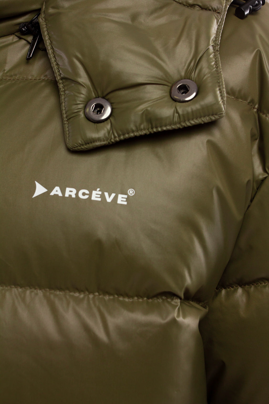 ARCÉVE The Mont Jacket - Close-up of the signature ARCÉVE logo on the chest  -  Khaki