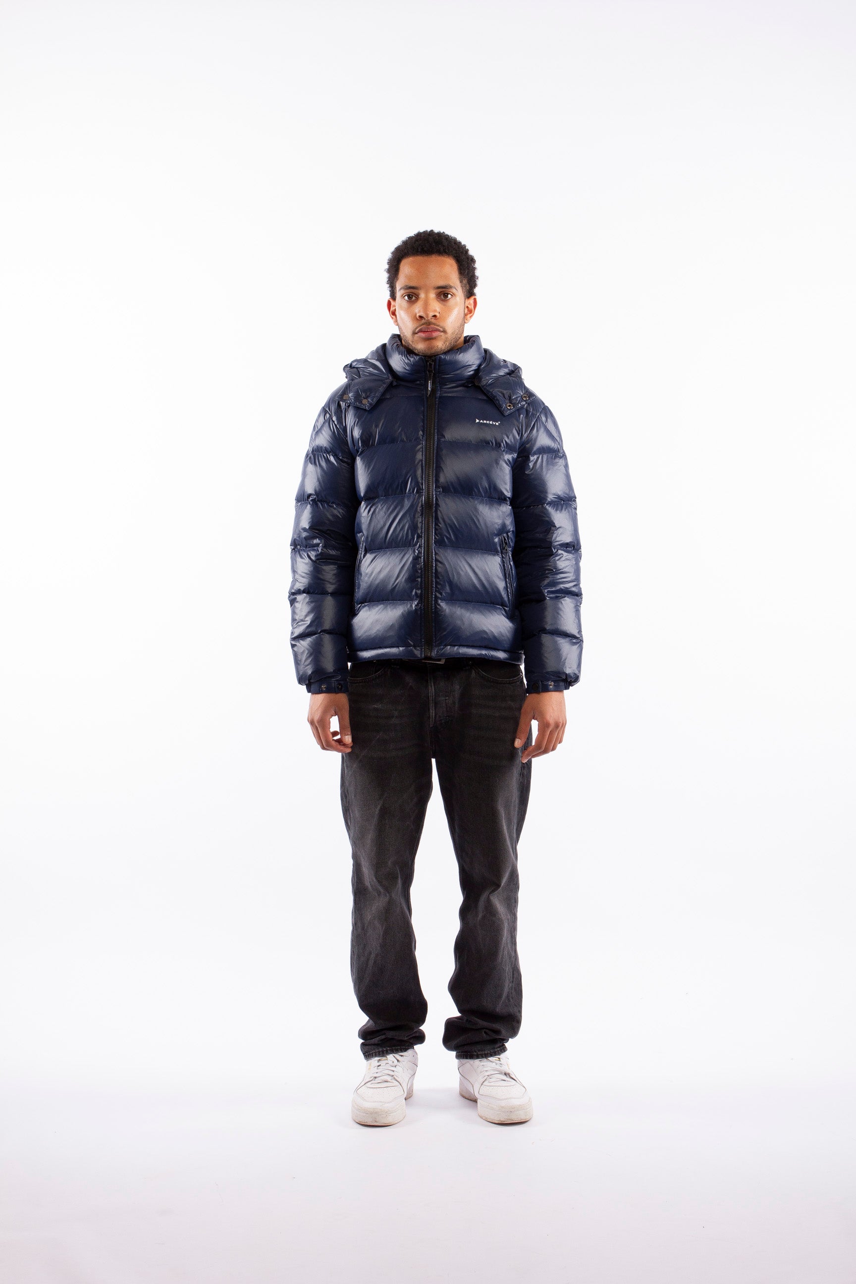 ARCÉVE The Mont Jacket - Model wearing the premium down puffer jacket - Navy